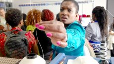 Barbara Rwodzi of Zimbabwe checks out the thread at the LA Fashion Institute.