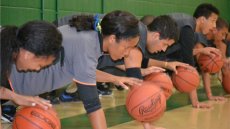  The Brazilian visitors work on dribbling by performing one-handed push-ups.