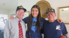 Gulnar posing with veterans she visits at their nursing home