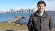 Nodirjon poses on Ellis Island in New York City, NY.