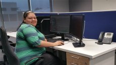 Woman seated in front of a computer in an office