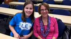 Woman sitting next to a teenaged girl