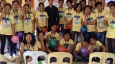 Large group photo of kids in classroom smiling