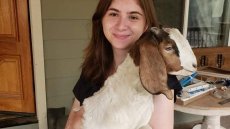 image of Kuzawinska holding a goat