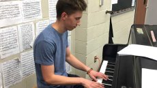 Young man playing a piano