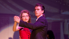 Jara dances with a partner in a school performance