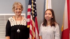 Older woman standing next to a teenaged girl