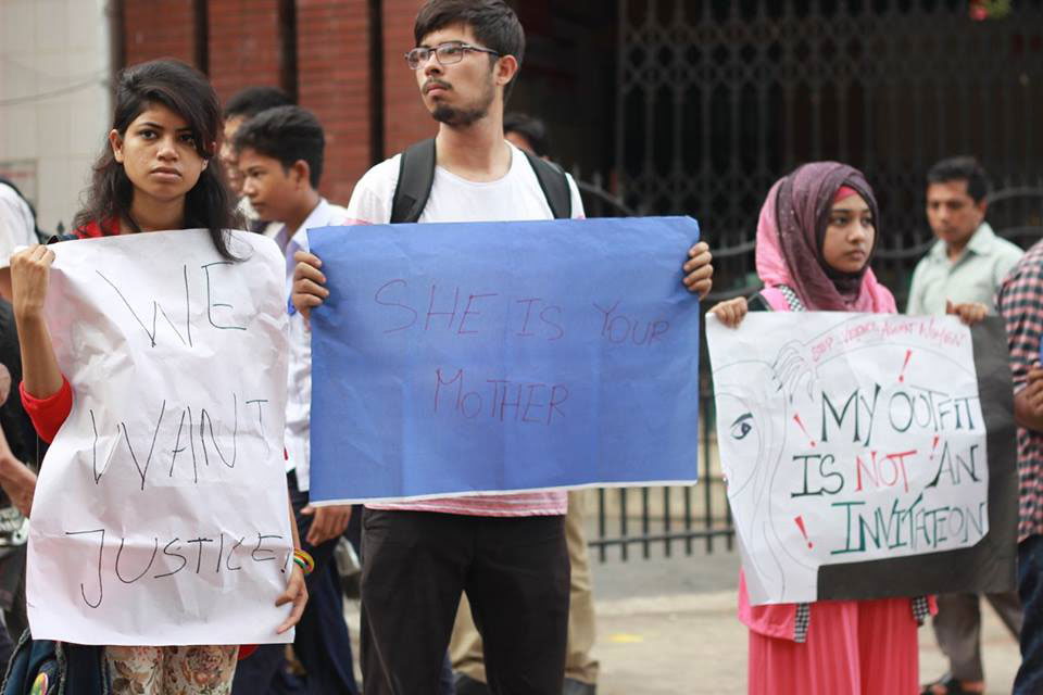 Three young people holding signs in what appears to be a protest