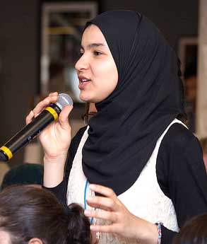 Girl holding microphone to ask question